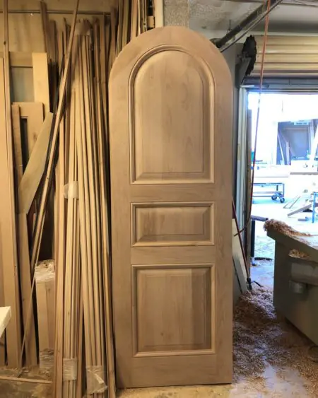 Single entry wood door with classic applied molding panels